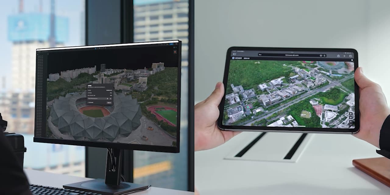En dator och en surfplatta visar detaljerade 3D-kartor av ett stadsområde, vilket illustrerar avancerad kartteknologi.
